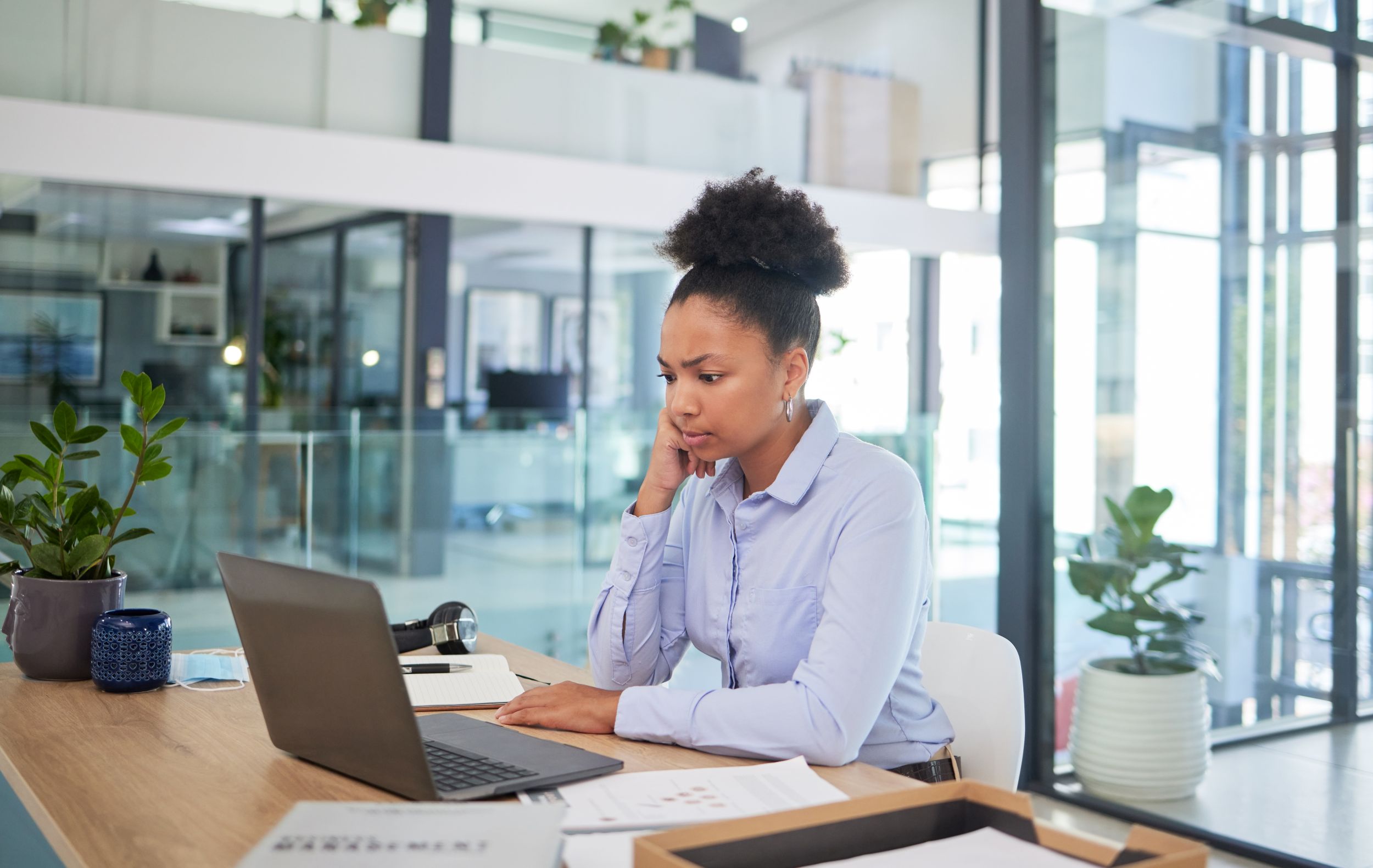 Lady at an office desk looking into a computer